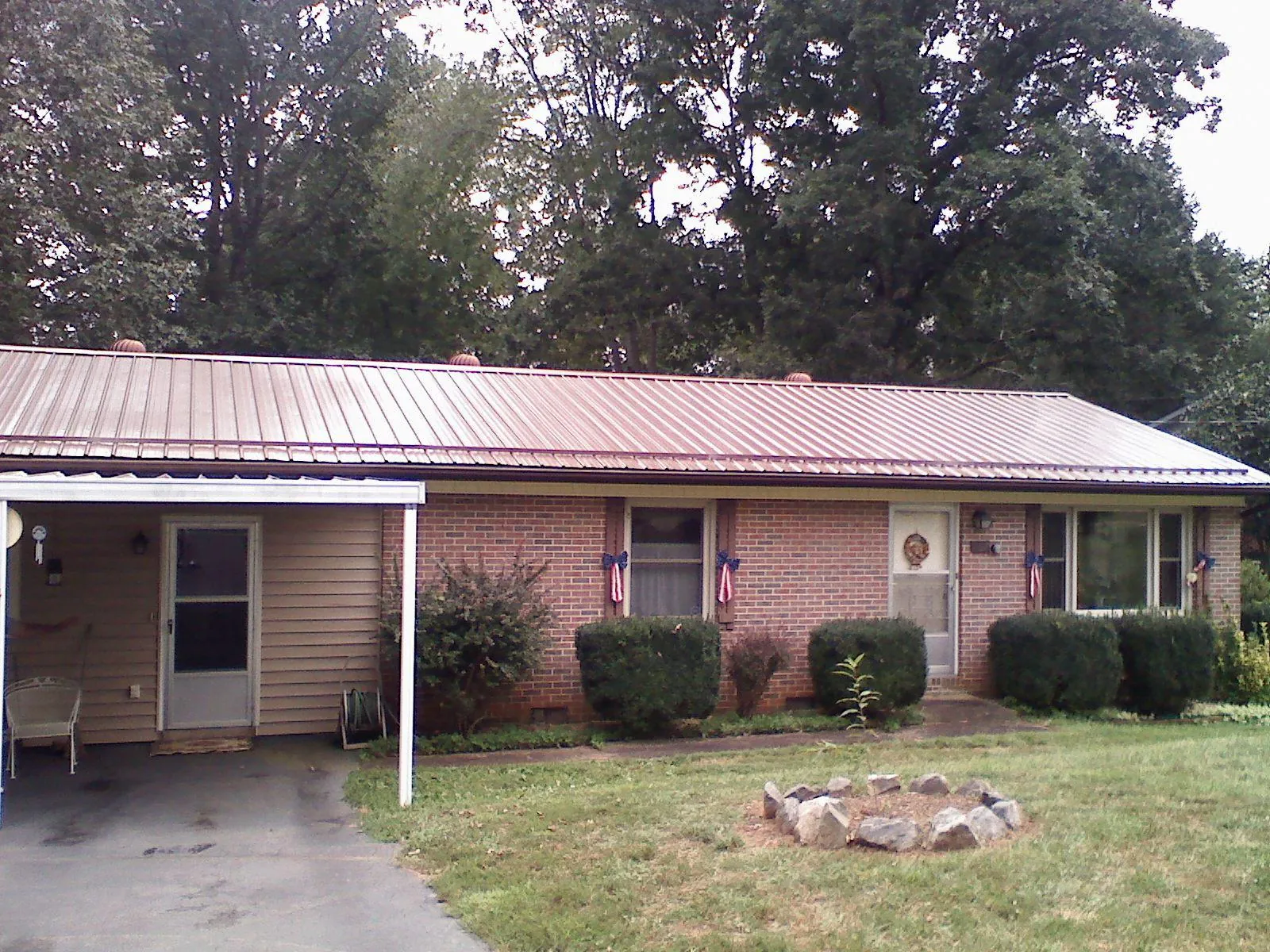 Bronze metal roof and carport on a brick ranch home — Roof Repair work by our crew in Far Hills