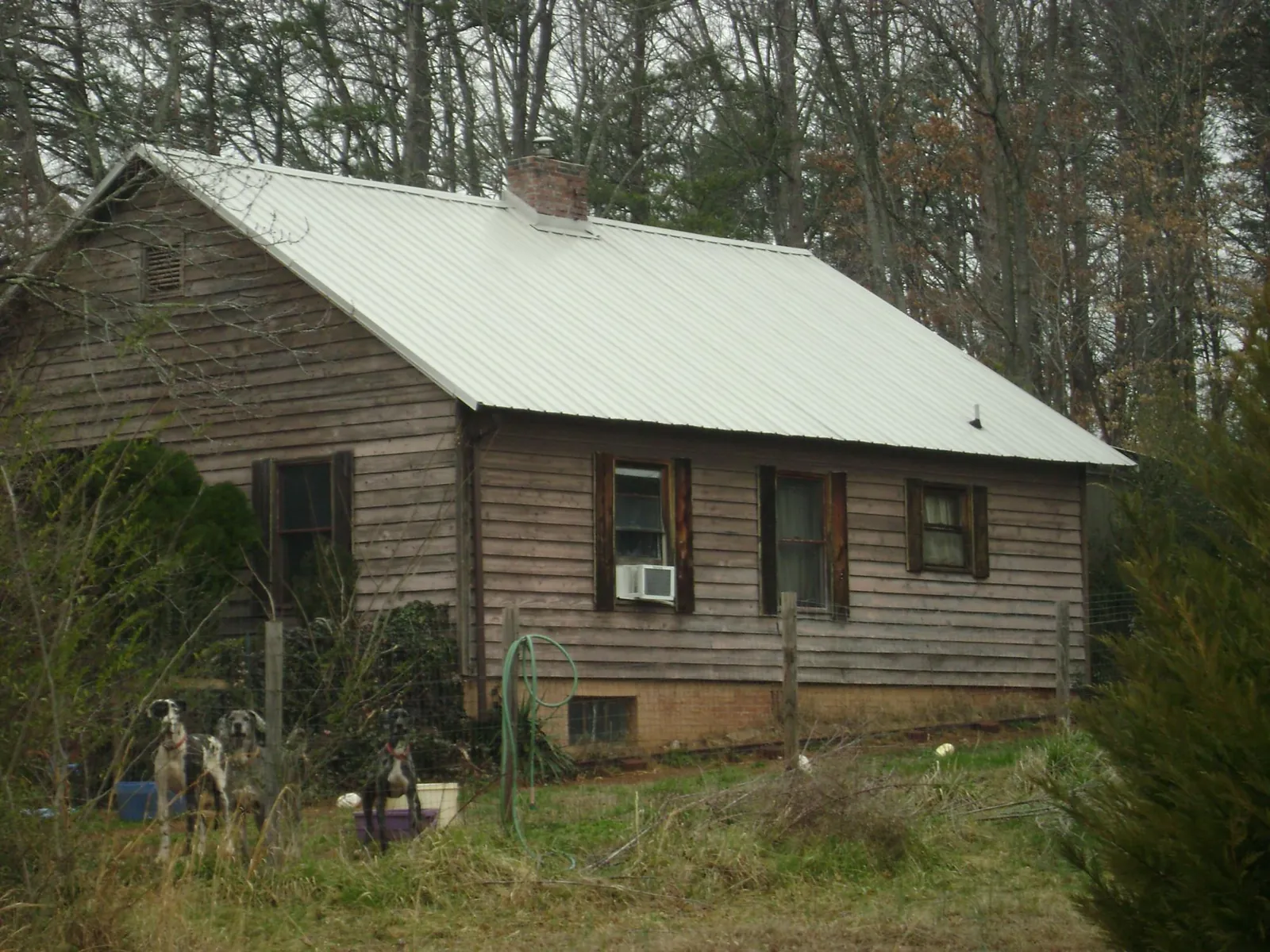 White metal roof on an old wood sided farmhouse, from a Metal Roof Installation job in Far Hills